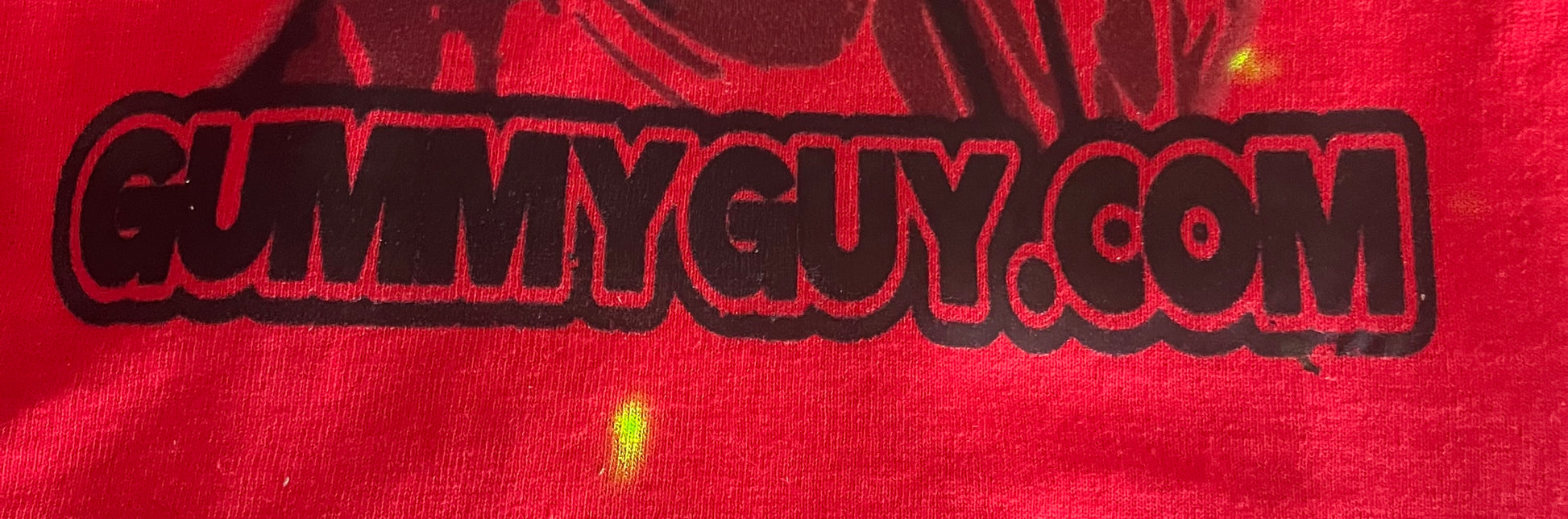 Red fabric with 'GummyGuy.com' printed in black.